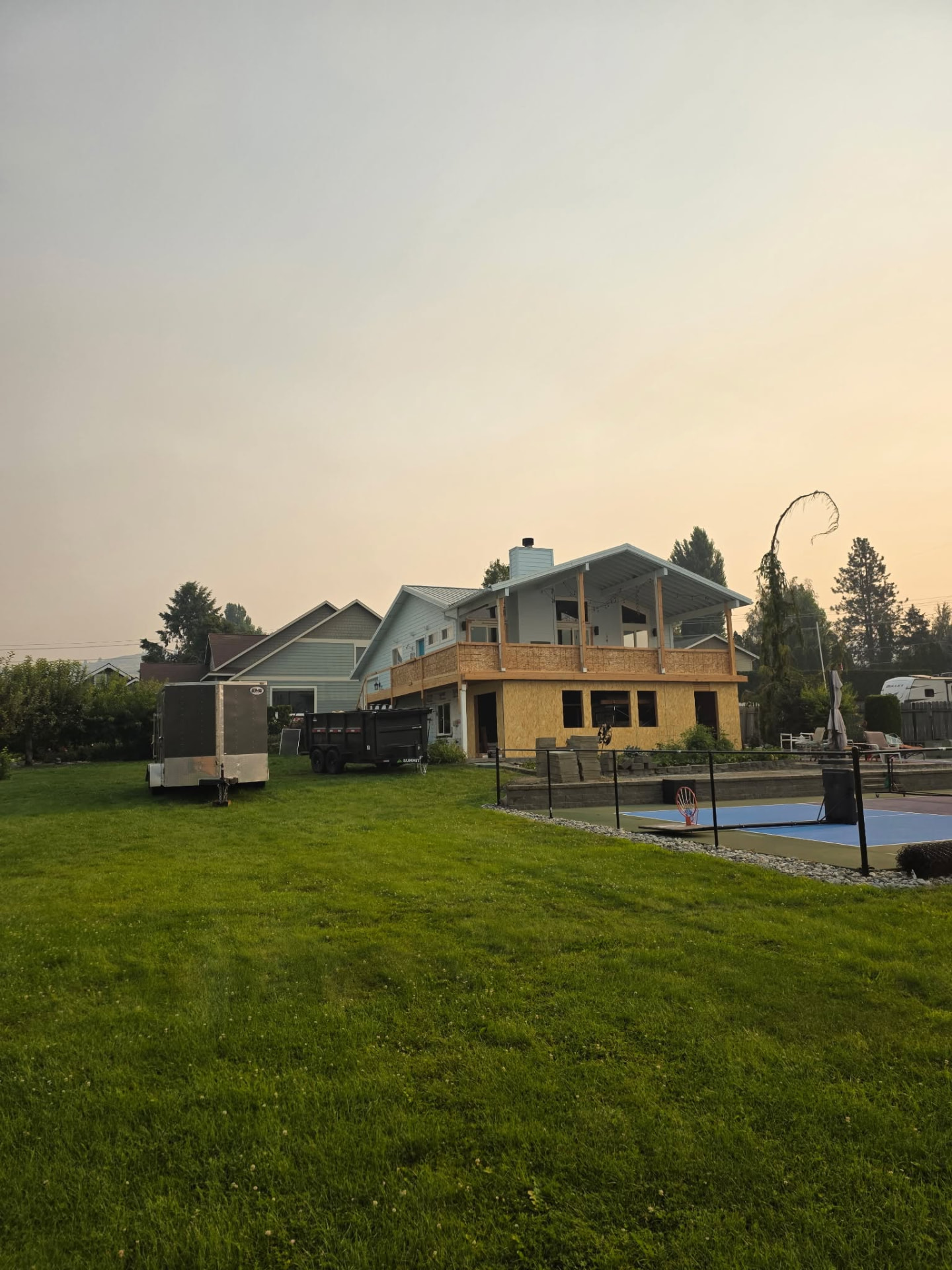 Exterior home renovation with new deck and sport court in Chelan, WA by Garcia Home Renovations