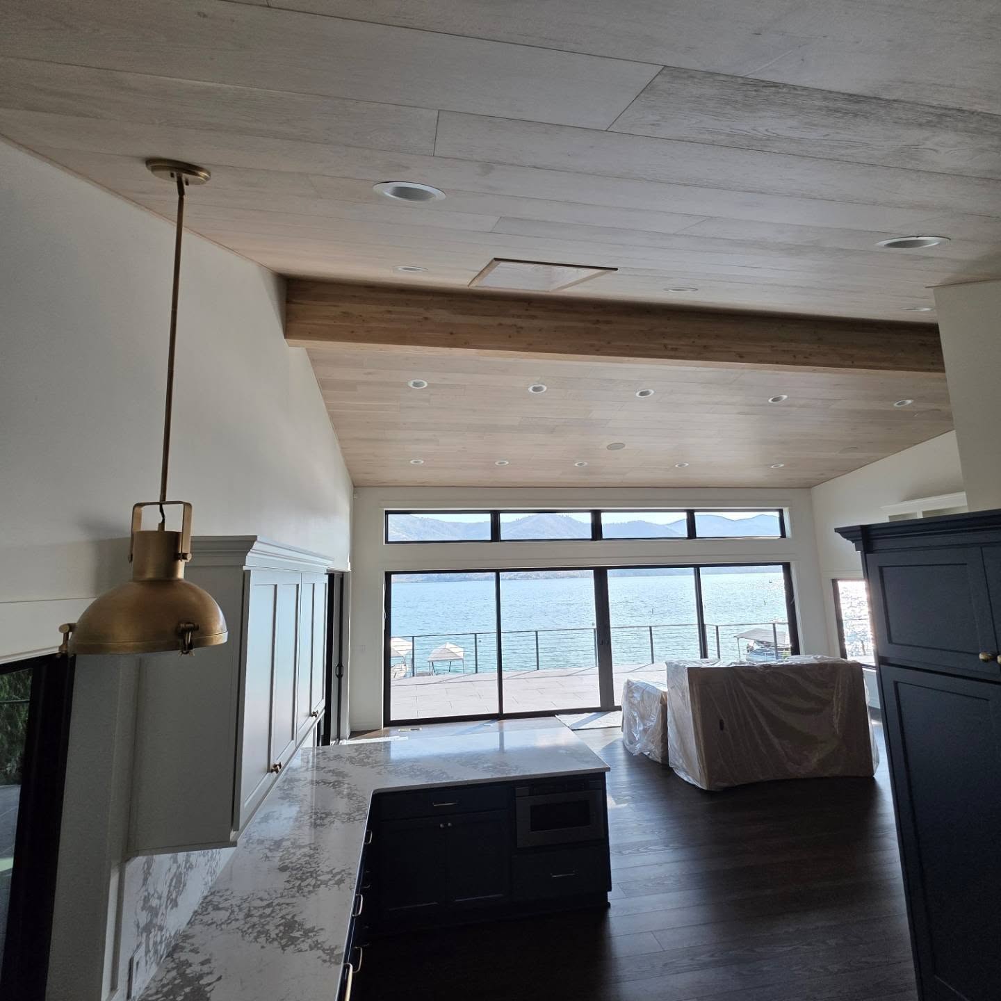 Custom white oak plank ceiling install in a Manson WA lake home by Garcia Home Renovations