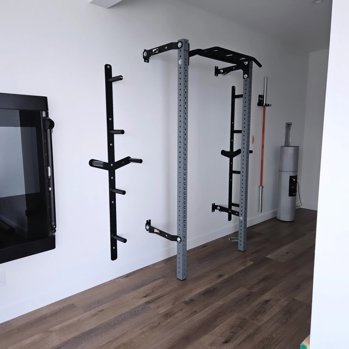 Custom home gym installation with wall-mounted squat rack and full mirror wall in Chelan WA by Garcia Home Renovations